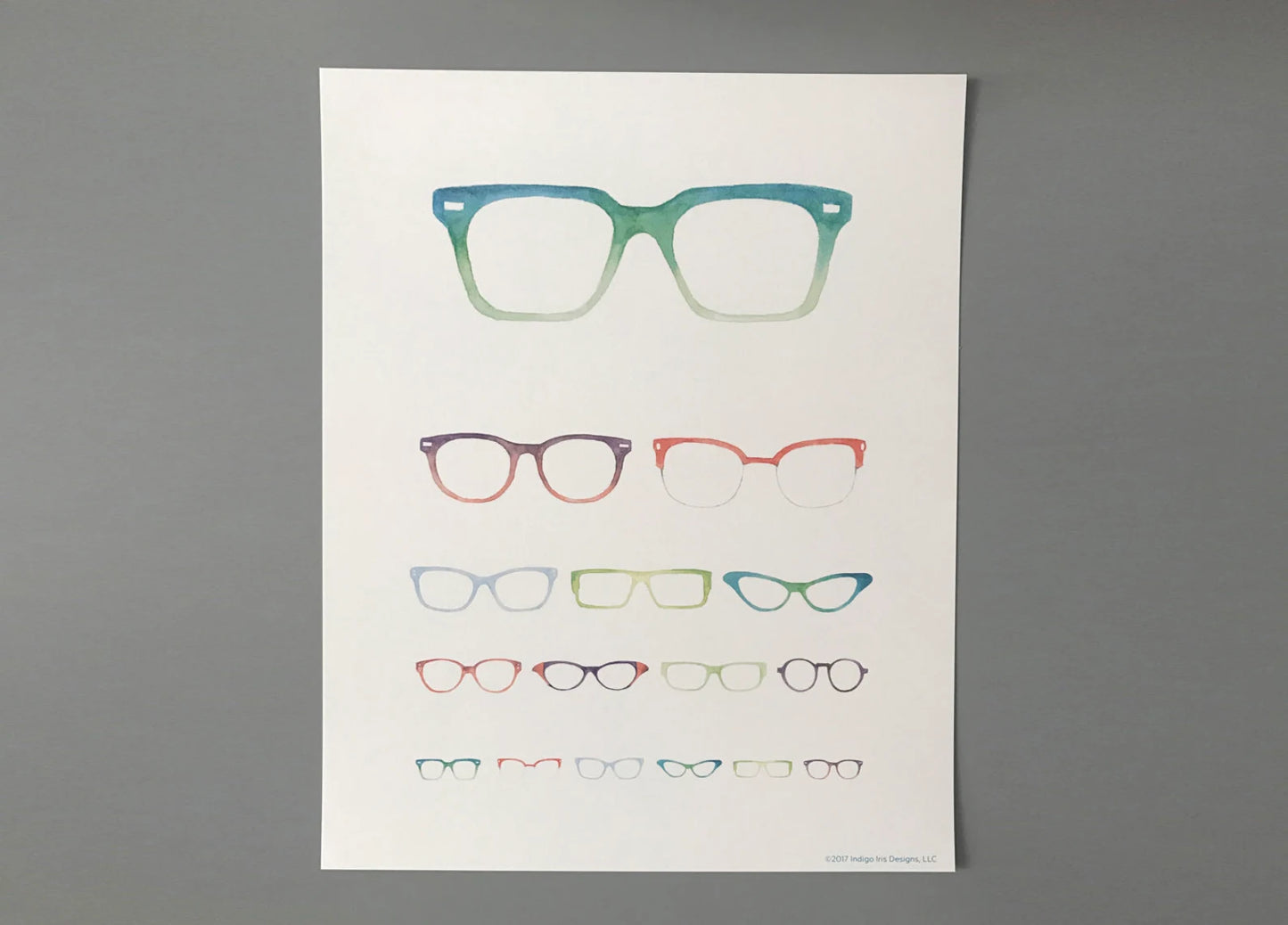 A print of an eye chart made up of varying sizes and styles of glasses. 